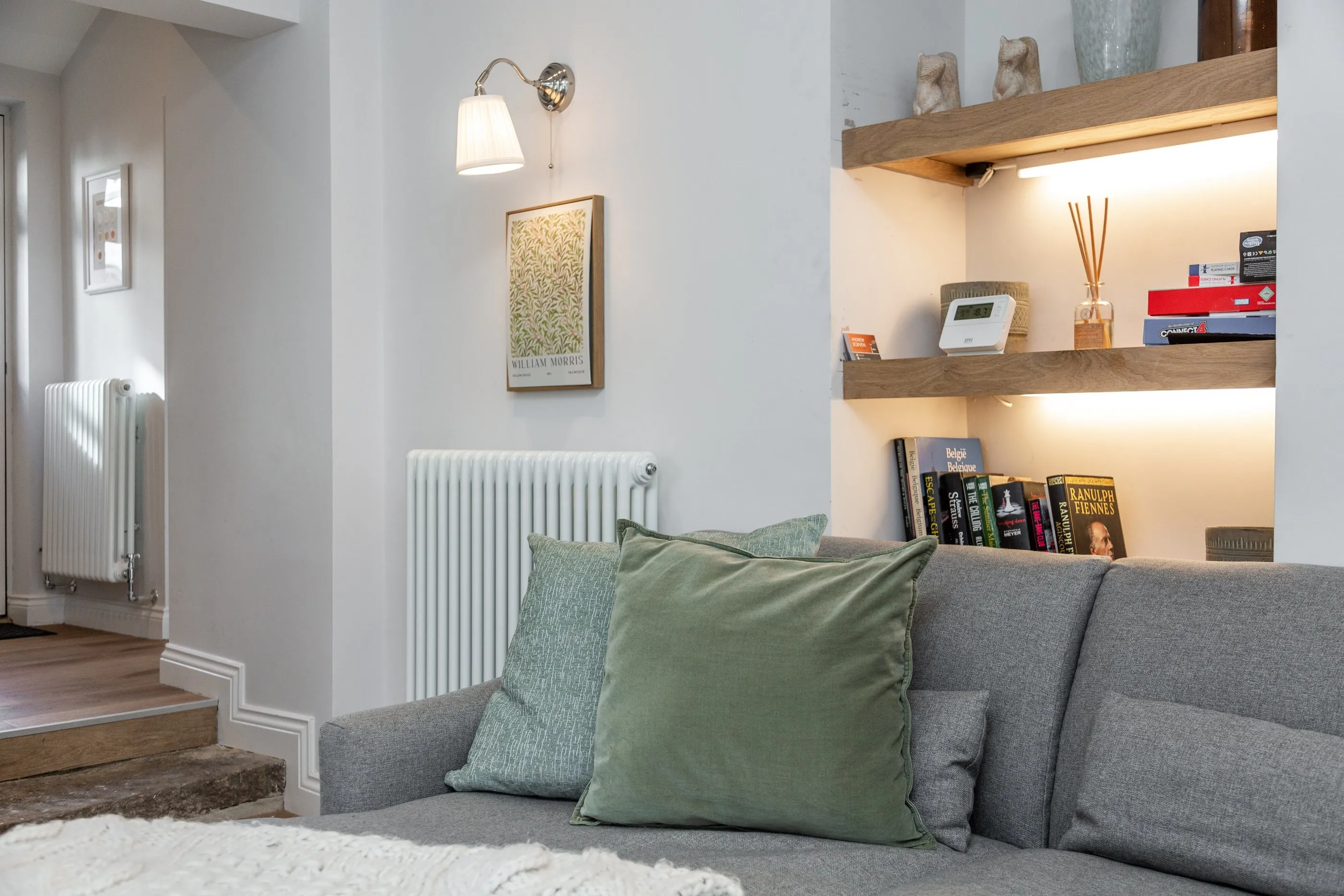 Books, games and a William Morris print by the sofa