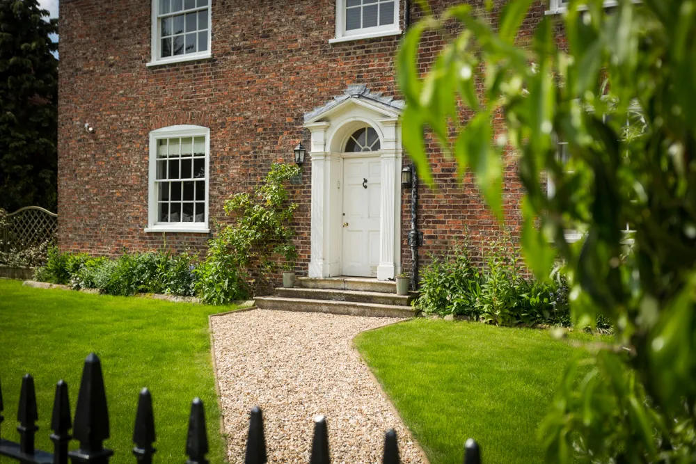 Gravel path leading to the pedimented Georgian front door