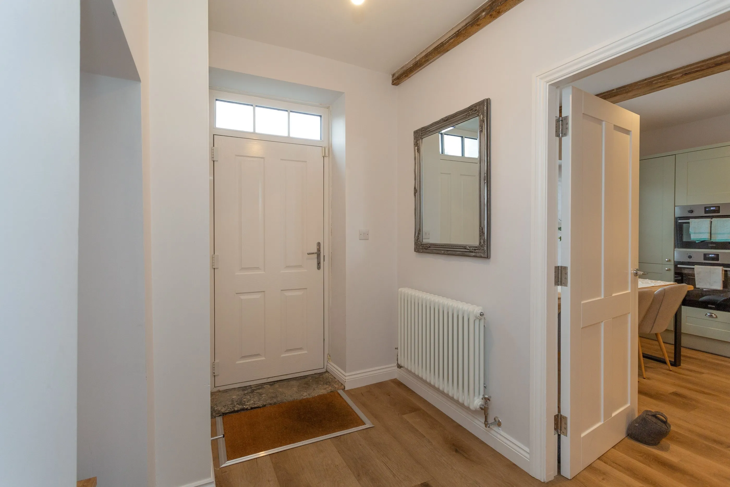 Entrance hall with a column radiator and view through to the kitchen