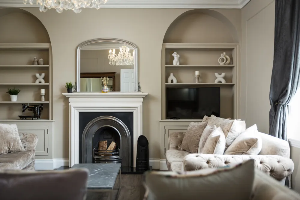 Fireplace with arched alcove shelving in the sitting room