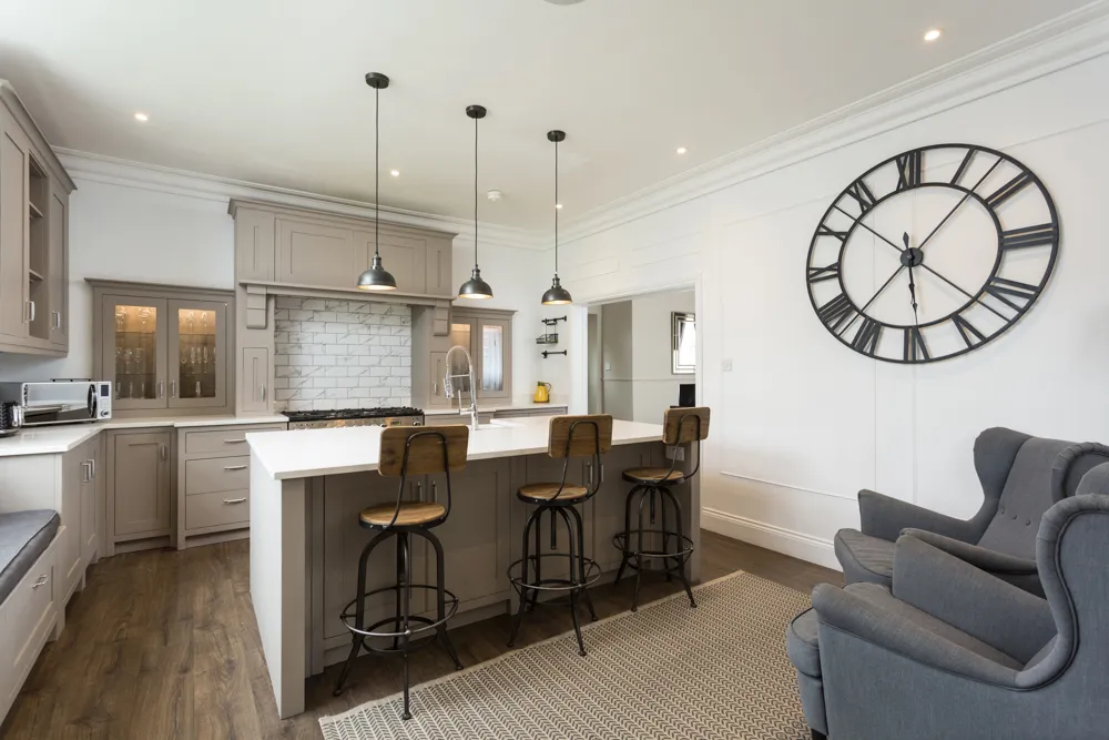 Shaker kitchen with island, range cooker and wingback chairs
