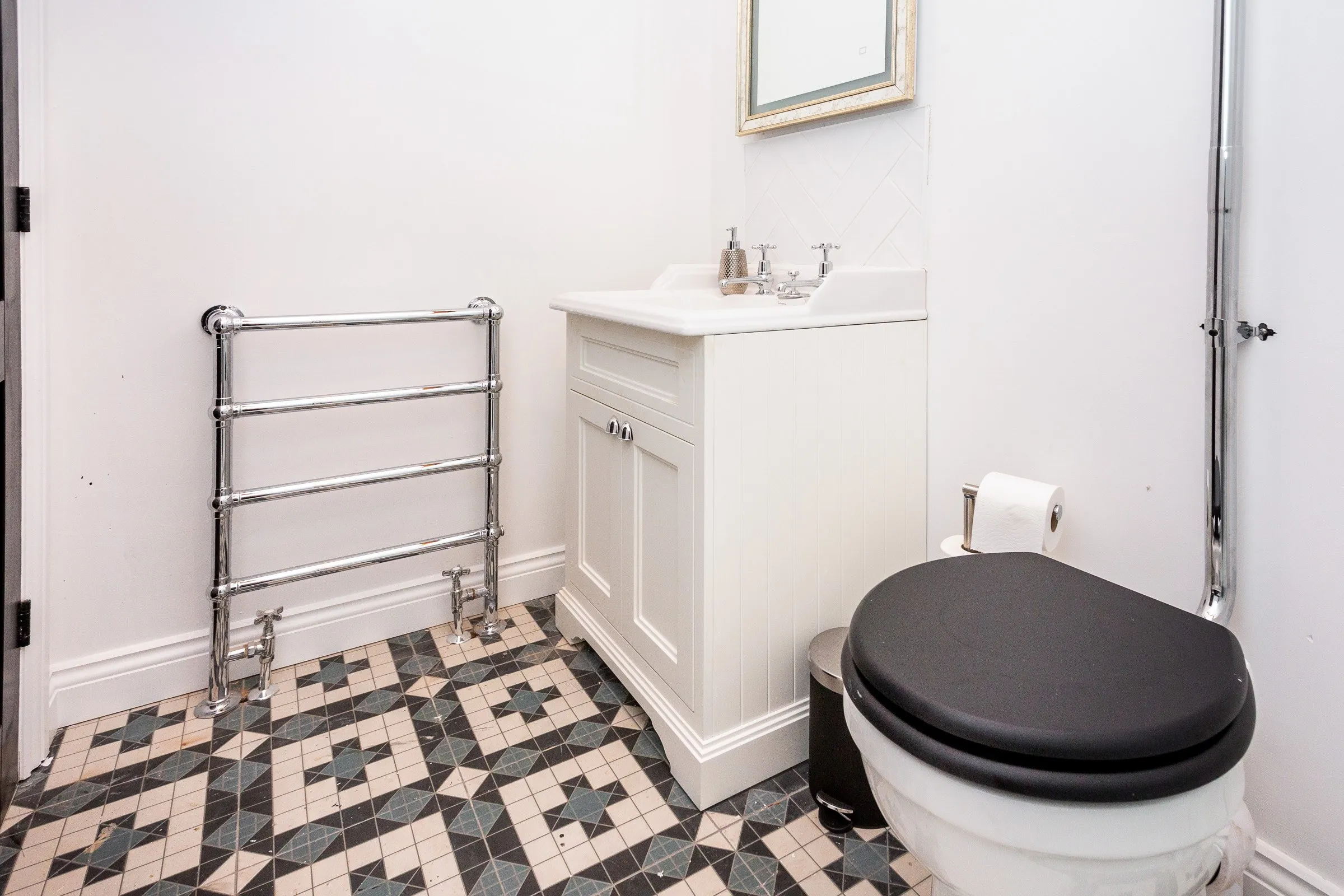 Cloakroom with basin and heated towel rail