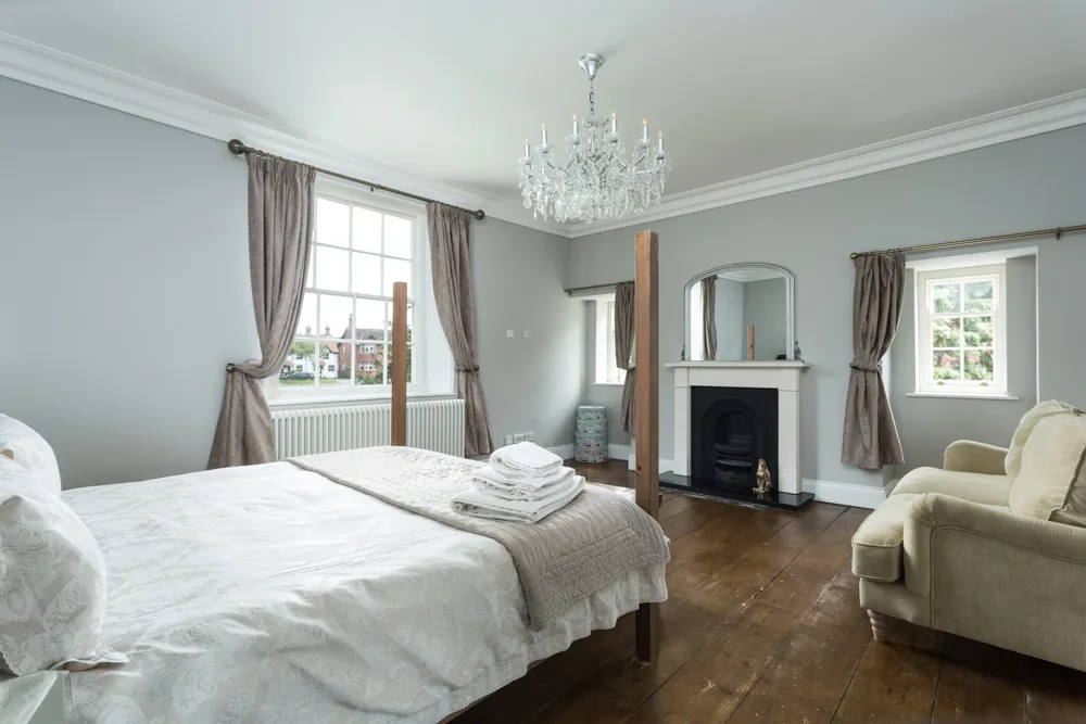 Principal bedroom with four-poster bed and fireplace