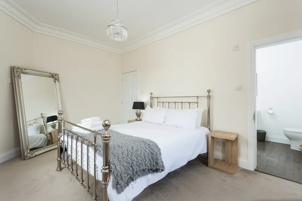 Bedroom with brass bed and private bathroom