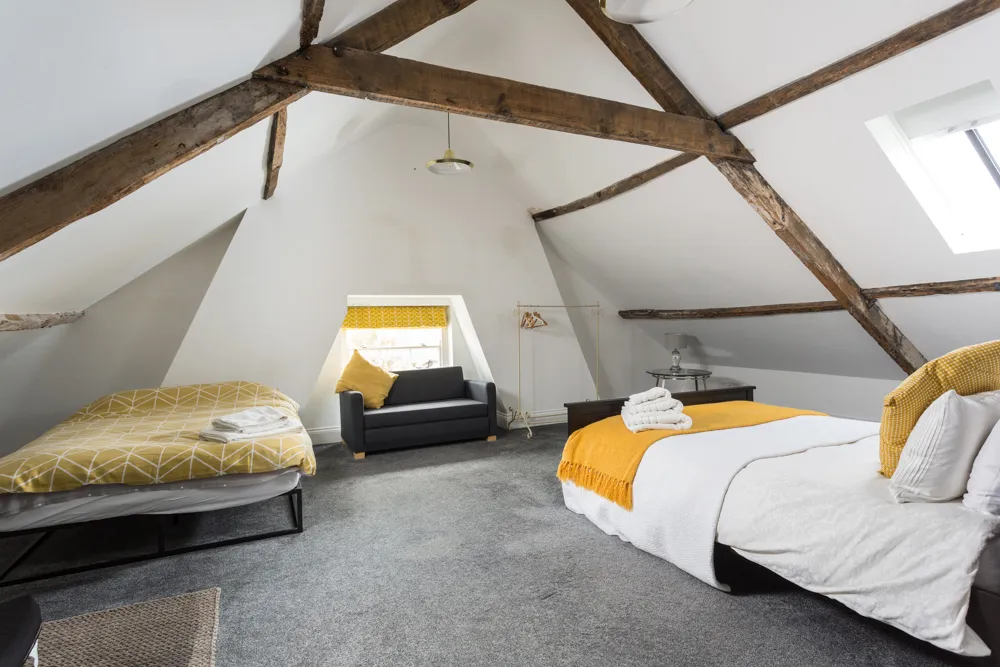 Loft bedroom under exposed oak beams