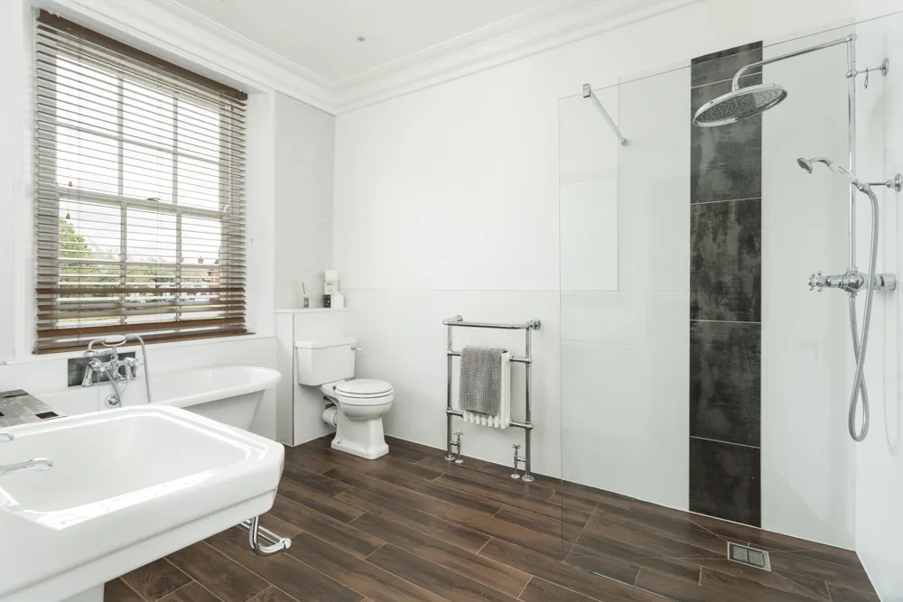 Bathroom with roll-top bath and walk-in shower