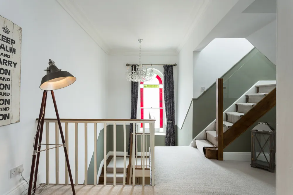 First-floor landing with chandelier and arched window